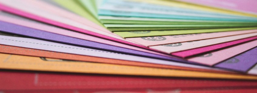 Photo by Andrew Pons on Unsplash a close-up of many different colored papers