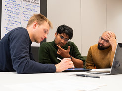 Three students think.