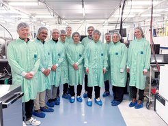A group of people in clean room clothing.