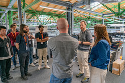 a group of students at the Mynaric facilities, guided by Clemens Jakubeit